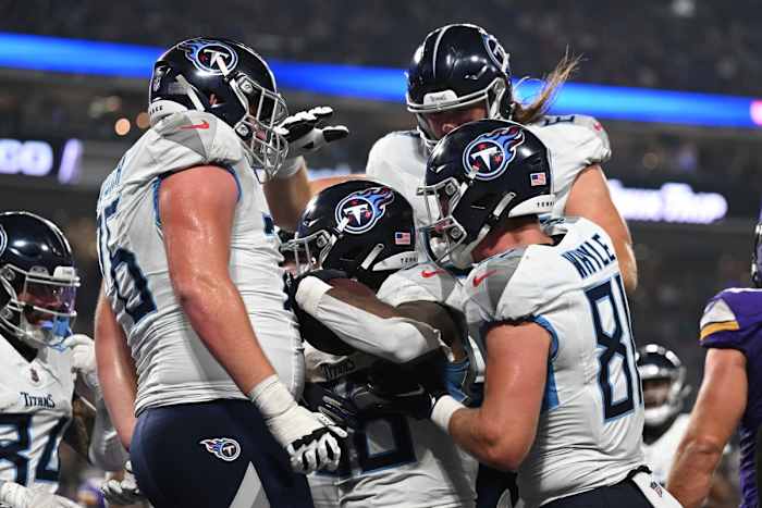 Tennessee Titans running back Julius Chestnut (center) and tight end Josh Whyle (81) and offensive tackle Andrew Rupcich (76) react with teammates after scoring a touchdown against the Minnesota Vikings during the fourth quarter at U.S. Bank Stadium.